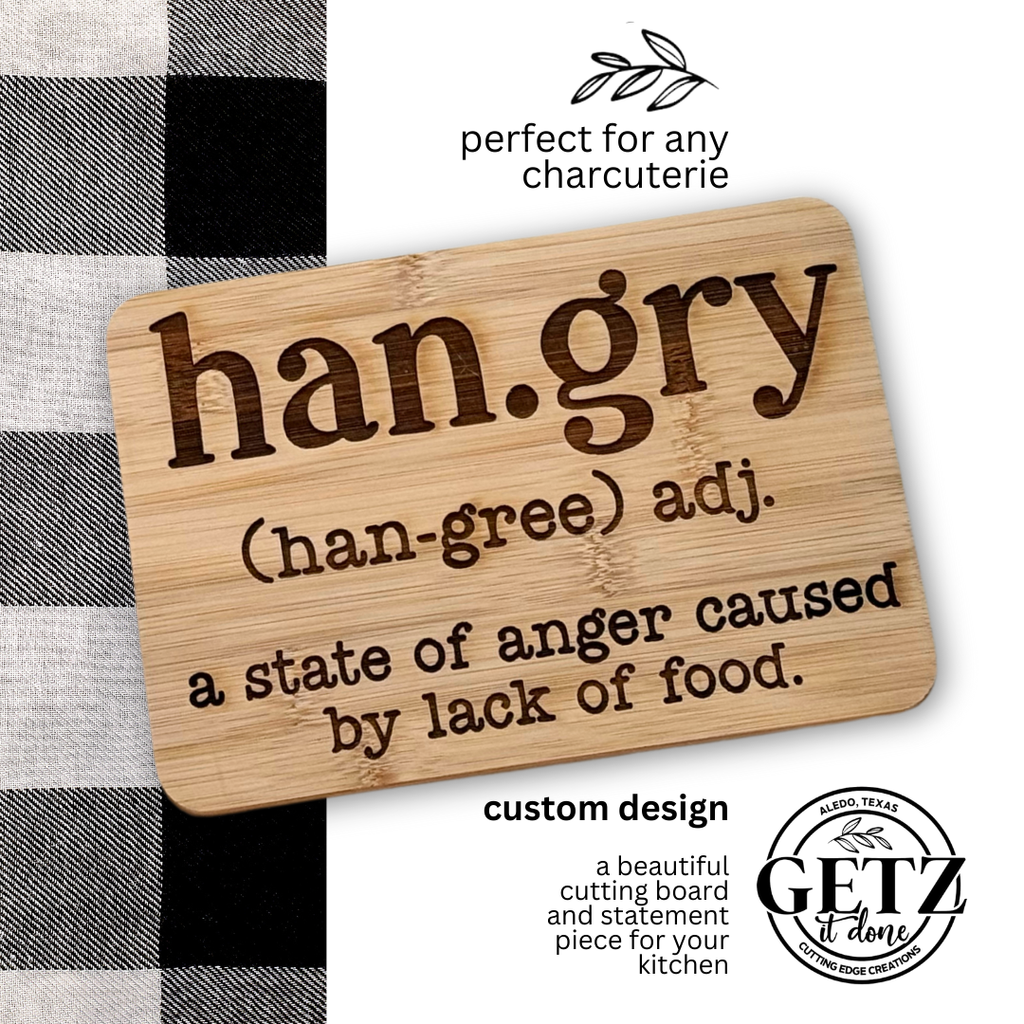 Wooden board with han.gry defined as a state of anger caused by lack of food. Text above reads perfect for any charcuterie, and below, custom design. A circular logo says GETZ it done. Black and white checkered fabric partially visible on the side.