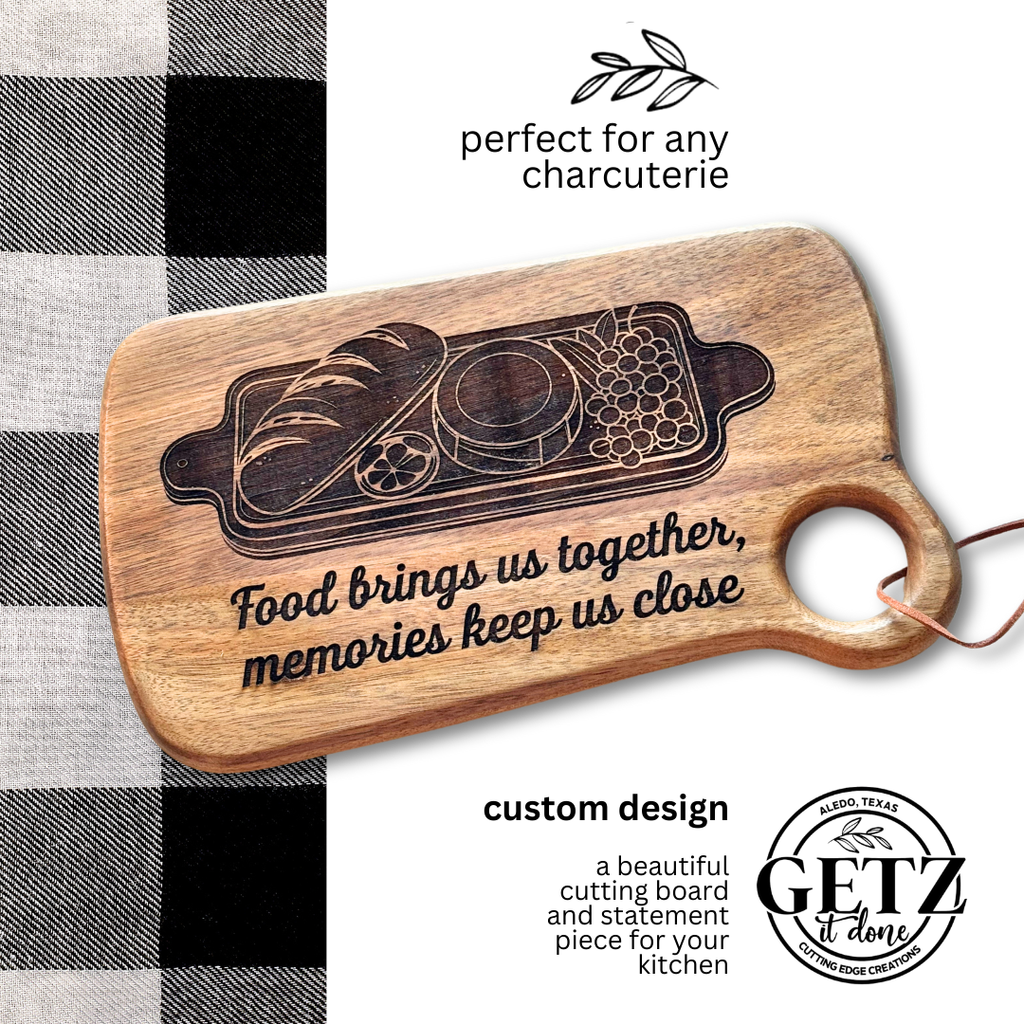 A wooden cutting board with etched charcuterie design and text: Food brings us together, memories keep us close. It lies on a black and white checkered cloth. Text reads, perfect for any charcuterie with a leaf graphic, and custom design with a circular logo and GETZ it done.