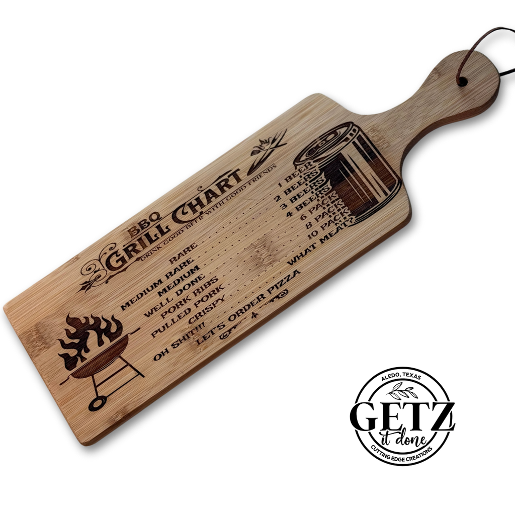 Rectangular wooden BBQ grill chart with a list detailing cooking levels from medium rare to well done and corresponding temperatures. It features engraved images of a flaming grill and a smoker. The handle has a leather loop, and the bottom reads Getz It Done with a circular logo.