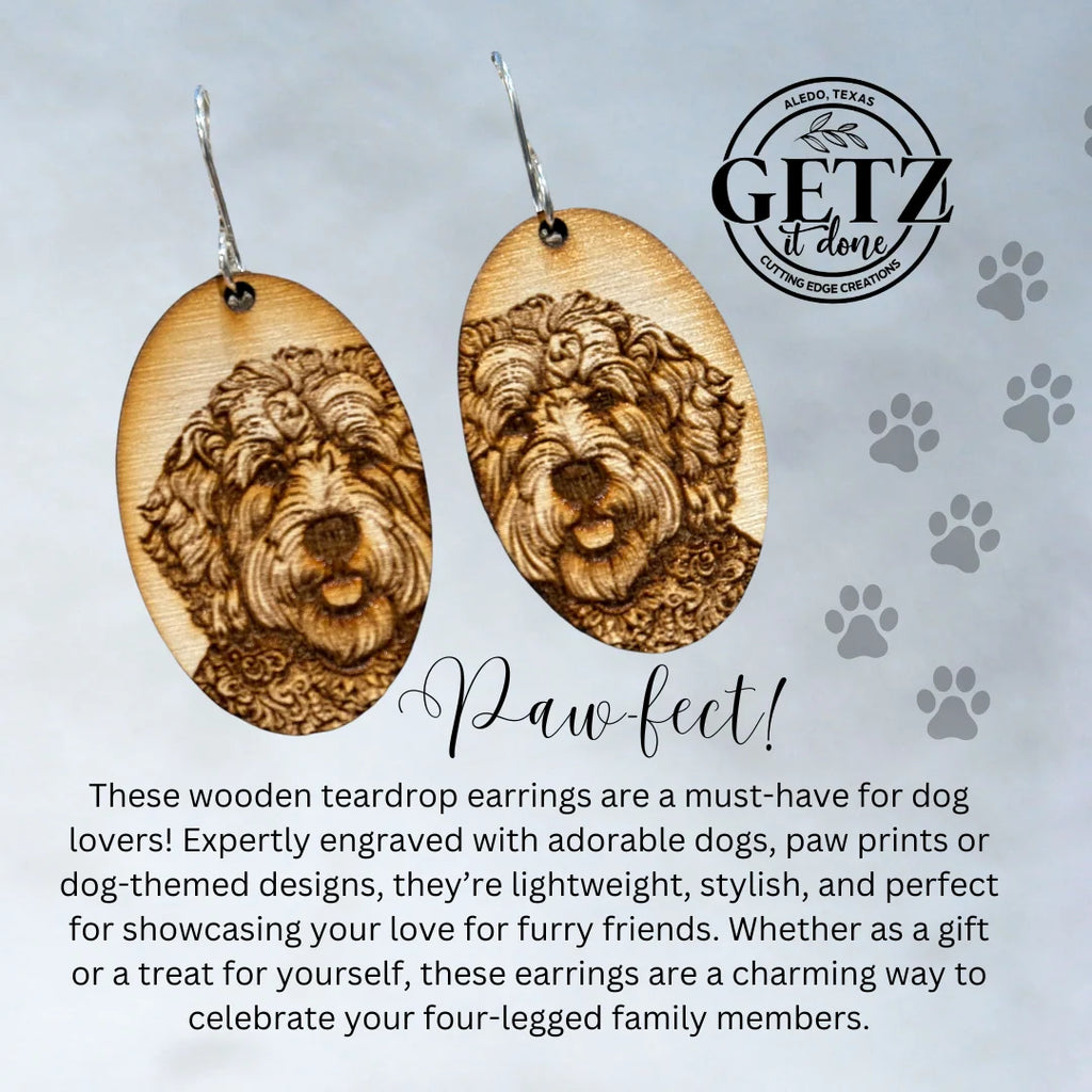 Oval wooden earrings with engraved images of fluffy dogs are displayed on a gray background. Text reads Paw-fect! with a description highlighting the earrings dog-themed designs and lightweight, stylish appeal. The GETZ it done logo with Cutting Edge Creations is visible at the top right.