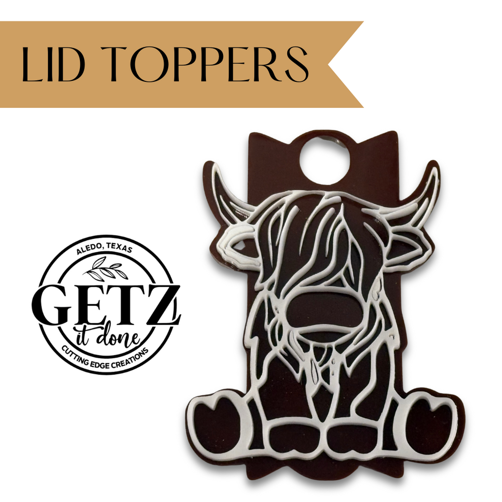 Illustration of a brown and white cow-shaped lid topper next to a circular logo that reads GETZ it done with ALEDO, TEXAS and CUTTING EDGE CREATIONS around the text. A tan banner above displays LID TOPPERS in bold font.