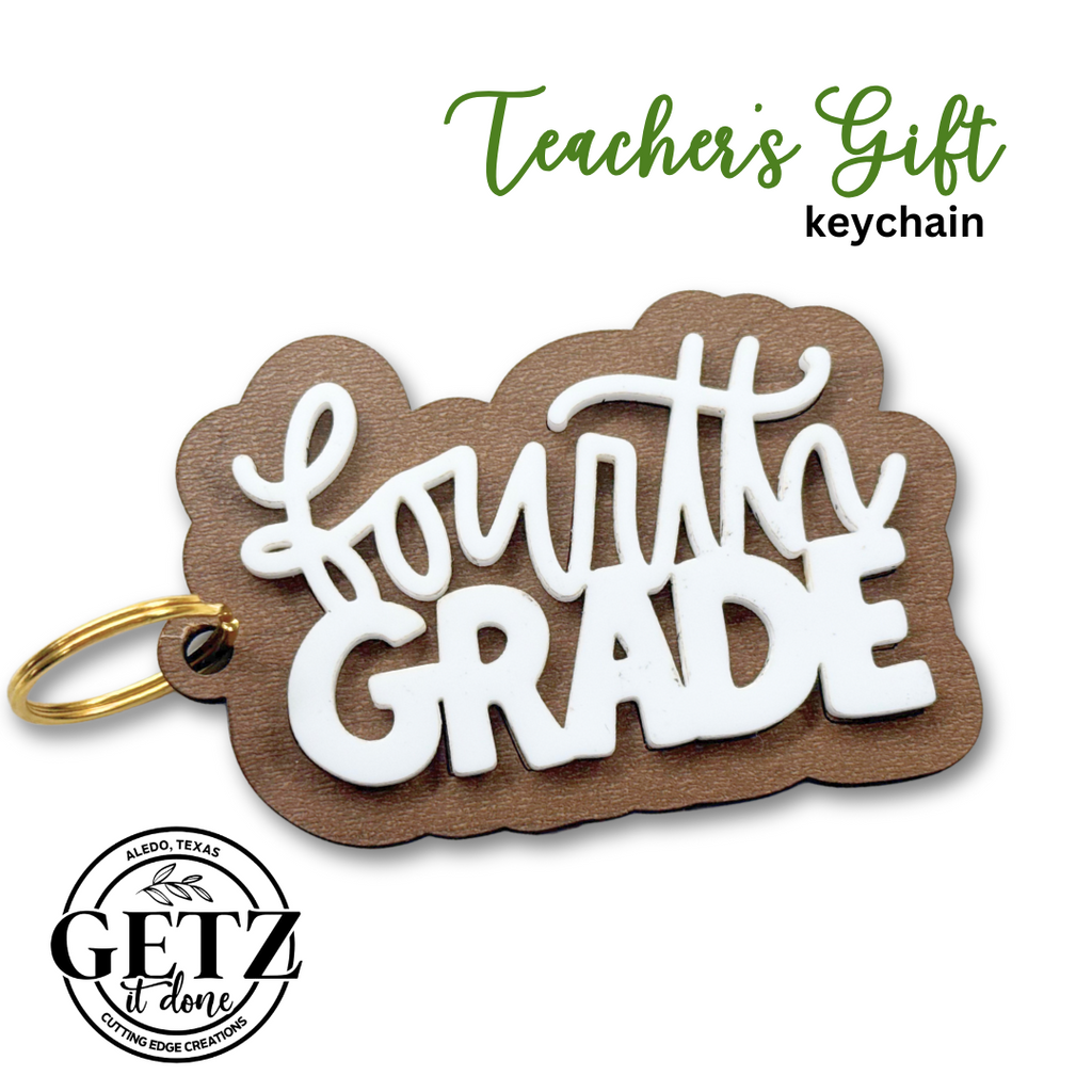 A keychain with the words Fourth Grade in white, raised lettering on a brown base. The keychain has a gold ring. Teachers Gift keychain is written in green and black text at the top. A logo at the bottom left reads Getz it done, Aledo, Texas, Cutting Edge Creations.