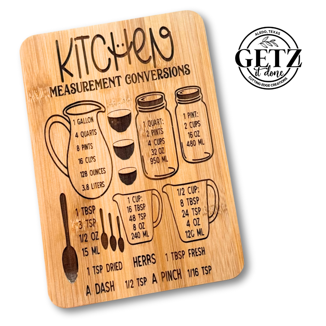 Wooden kitchen conversion chart with illustrations of measuring cups and spoons. Includes gallon, quart, pint, and cup conversions in milliliters, and tablespoons to teaspoons. Contains the text GETZ it done with a circular logo in the top right corner.