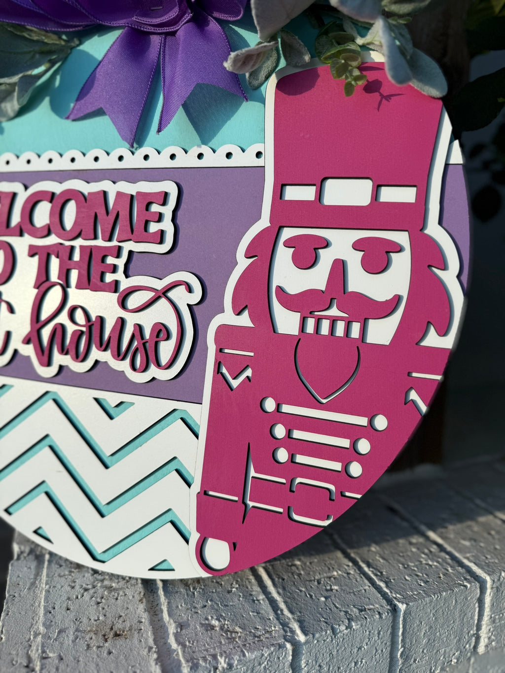 Welcome to the Nut House Door Sign – Nutcracker Christmas Wreath, 3D Layered Wooden Holiday Door Hanger with Purple Bow (16–20”)
