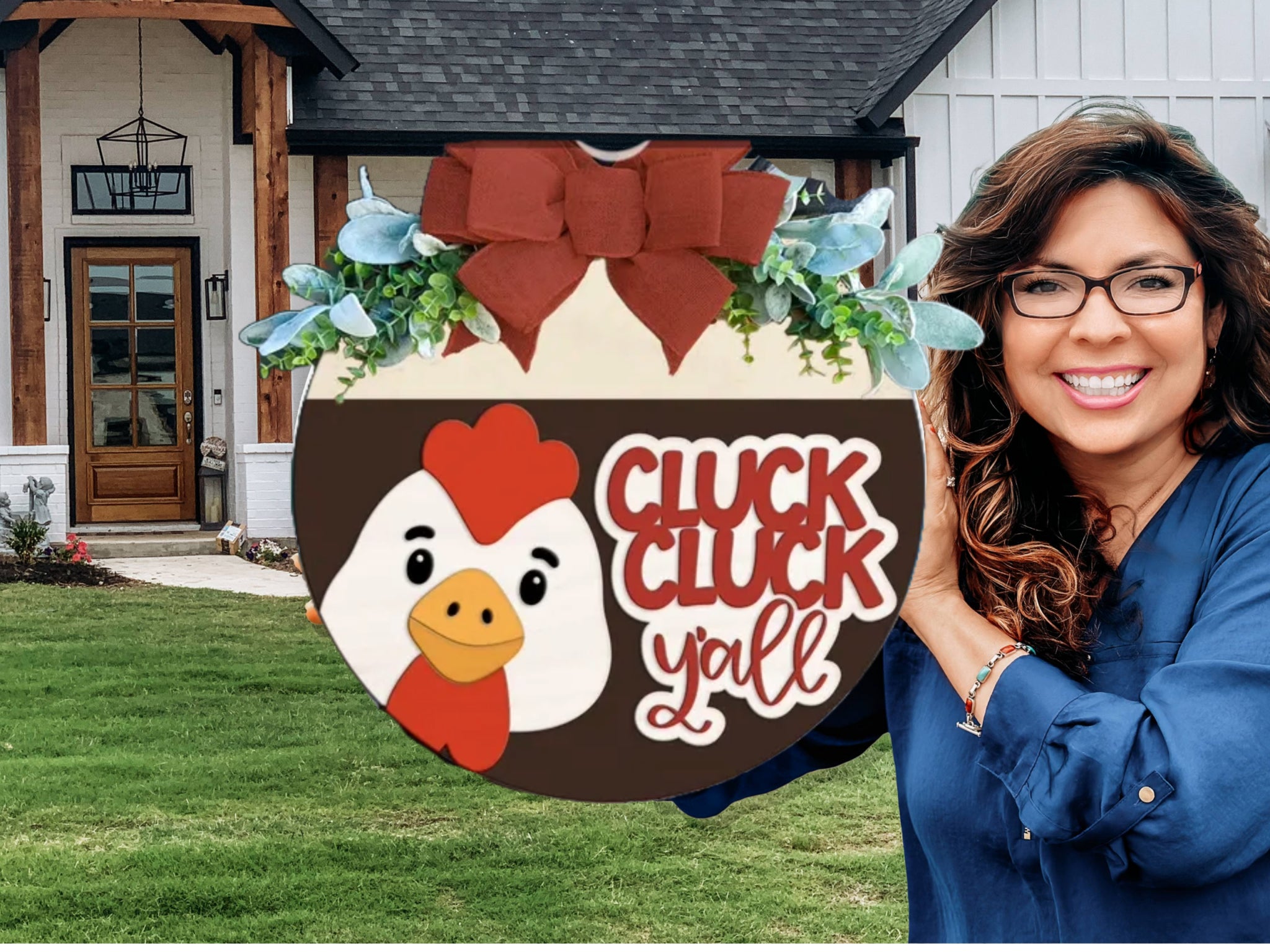 A smiling woman with long brown hair and glasses holds a round sign with a cartoon chicken and the words “Cluck Cluck Y’all” in front of a modern farmhouse-style home.