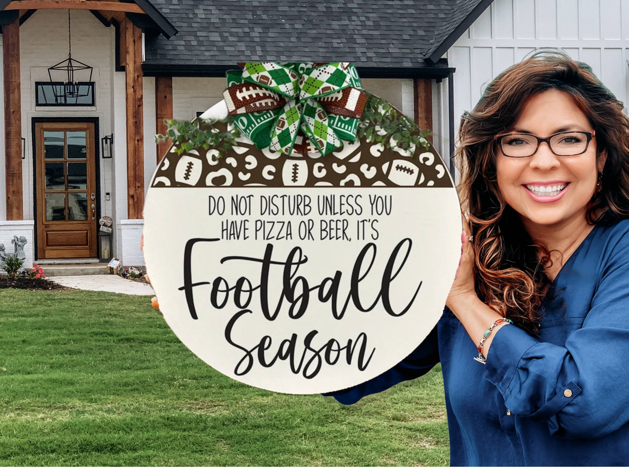 A smiling woman with long brown hair and glasses holds a round sign decorated with football motifs and a bow. The sign reads, “Do not disturb unless you have pizza or beer, it’s Football Season.” A house with a porch is in the background.