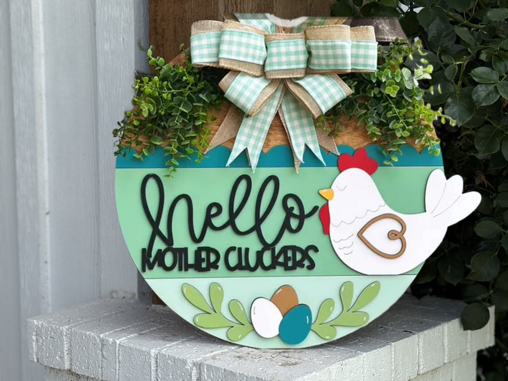 A rustic round wall sign reading "Welcome to Our Deck" with greenery, plaid bow, and farmhouse style—perfect outdoor decor for your porch or patio. Gather, chat, unwind with this charming door hanger.