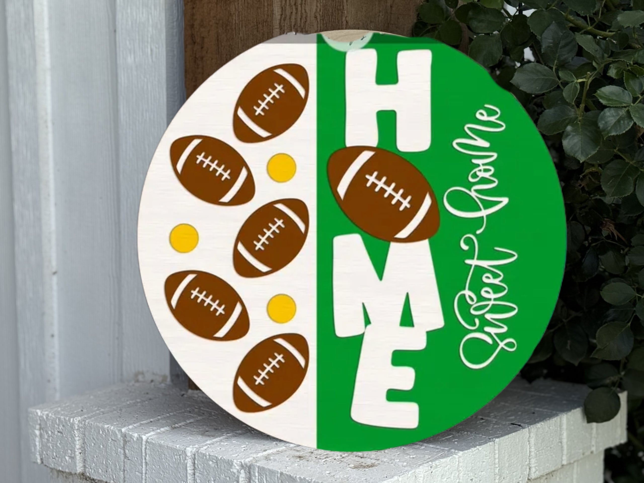 A round sign split in half; the left side is white with footballs and yellow dots, the right side is green with the word HOME in bold letters and Sweet Home written in script. A football replaces the letter O.