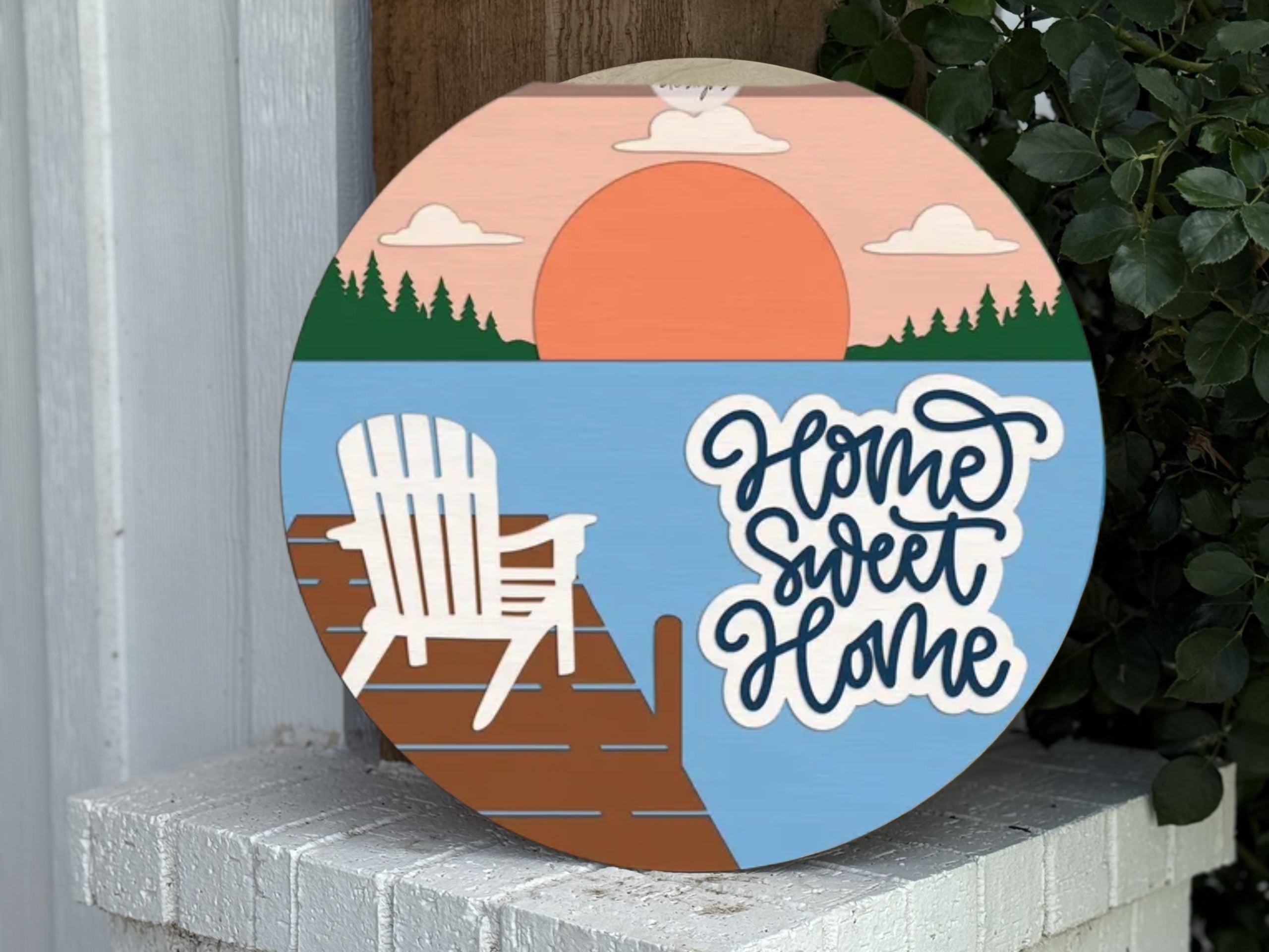 The "Welcome to Our Deck Sign" is a rustic farmhouse porch and patio decor piece featuring a lake scene, perfect for outdoor spaces. This door hanger invites you to gather, chat, and unwind on your deck or patio.