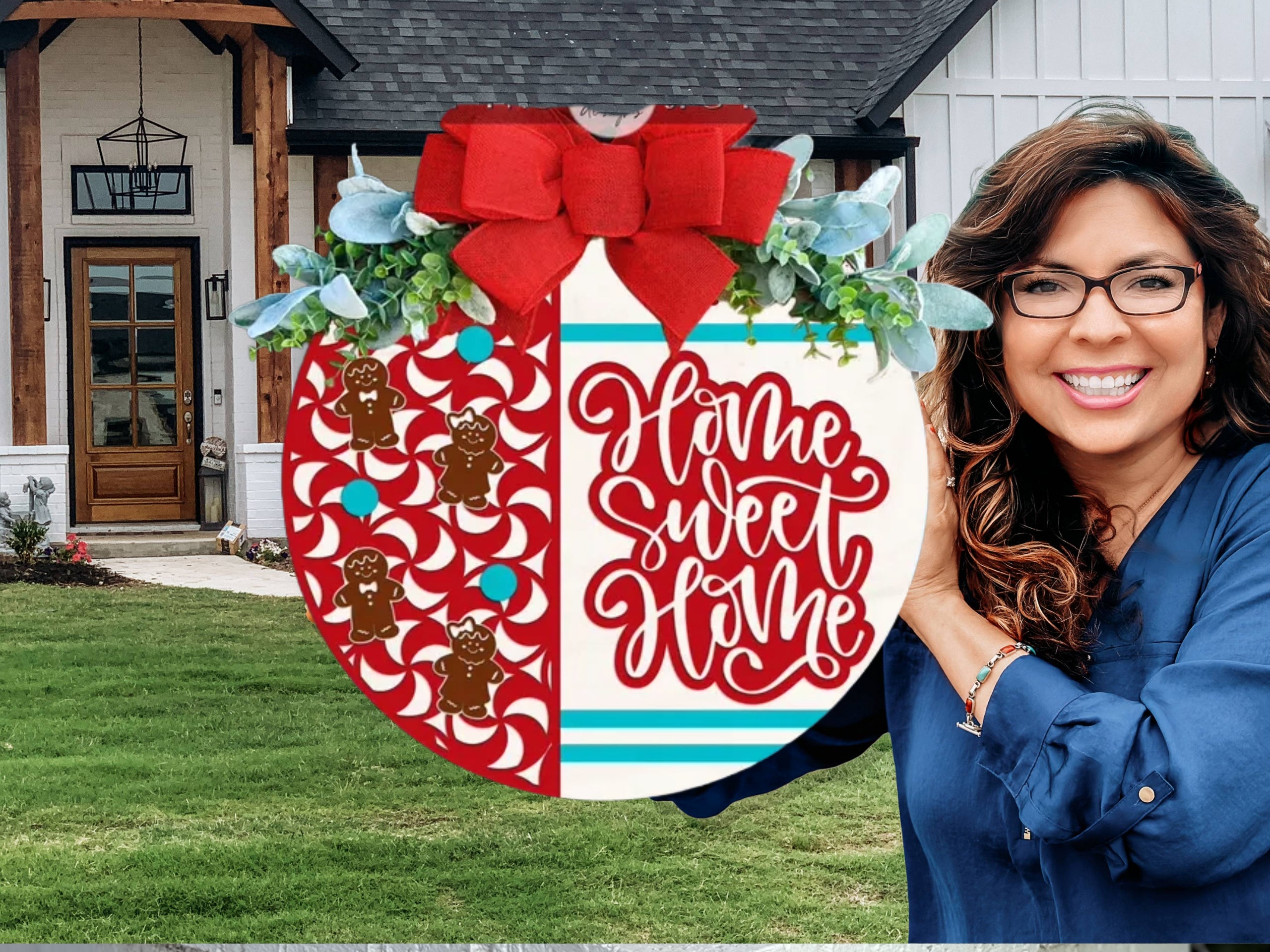 A festive round sign decorated with red and white peppermint patterns and gingerbread men on the left, Home Sweet Home in red script on the right, topped with a red bow and greenery, displayed on a white brick ledge.