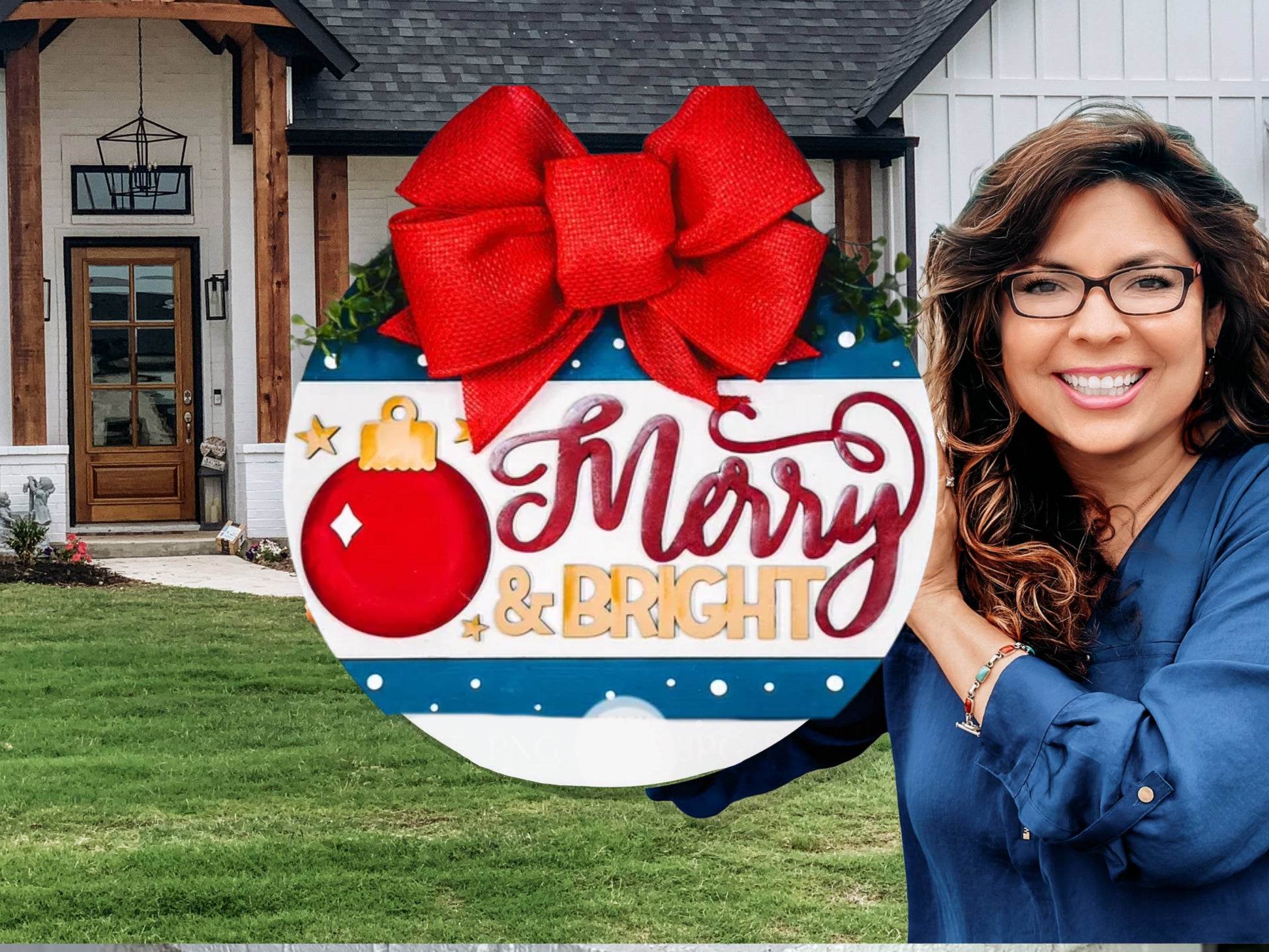 A smiling woman with wavy hair and glasses holds a round holiday sign with a red bow that says “Merry & Bright” in front of a modern house with a green lawn.
