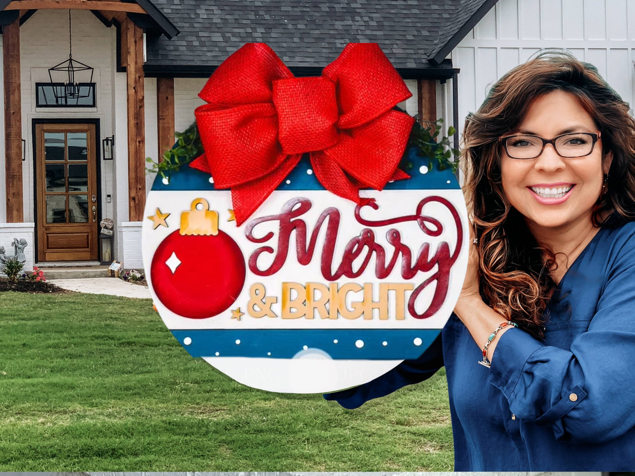 A smiling woman with wavy hair and glasses holds a round holiday sign with a red bow that says “Merry & Bright” in front of a modern house with a green lawn.