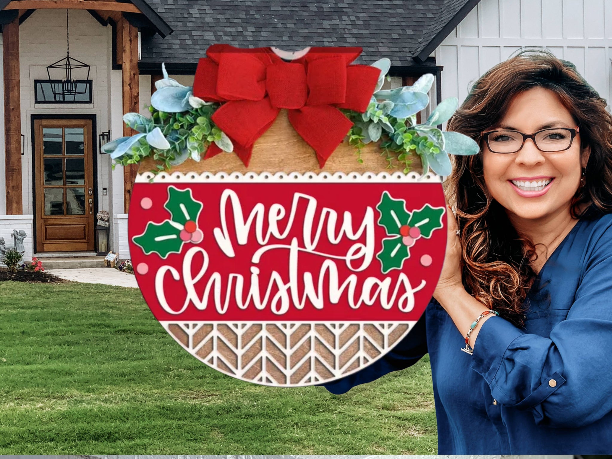 A smiling woman with long brown hair and glasses holds a round wooden sign decorated with a red bow and greenery. The sign reads Merry Christmas and features holly designs. A modern house with a lawn is in the background.