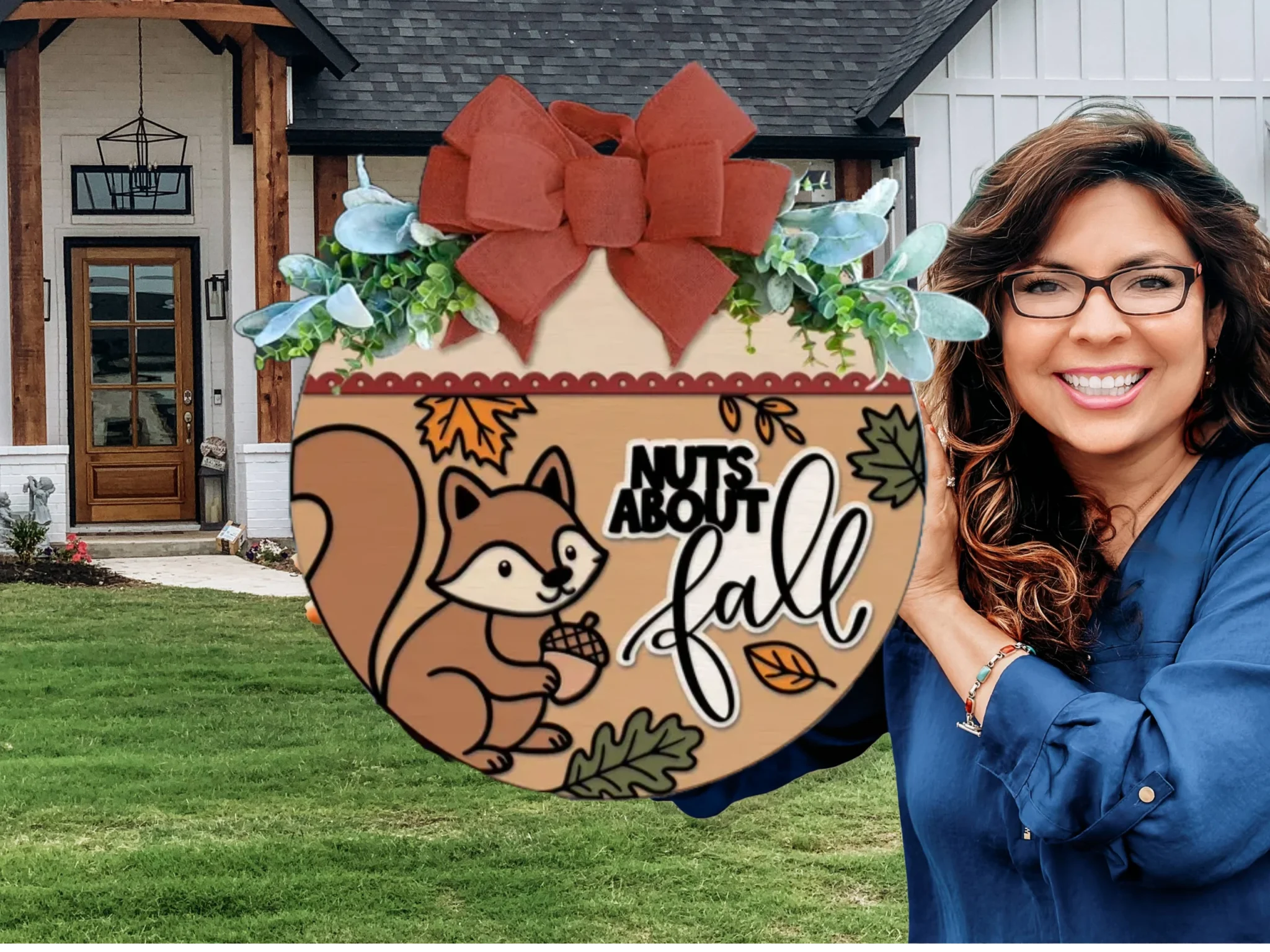 A smiling woman holds a round fall-themed sign with a squirrel, leaves, and the words Nuts About Fall in front of a modern house with white siding and wood accents.