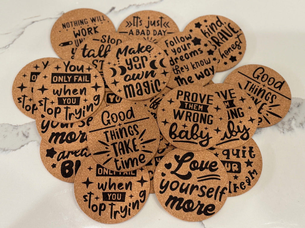 The Motivational Cork Coasters - Set of 4 feature round designs with quotes like Love yourself more and Good things take time, offering inspiration and stylish surface protection on marble or other surfaces.
