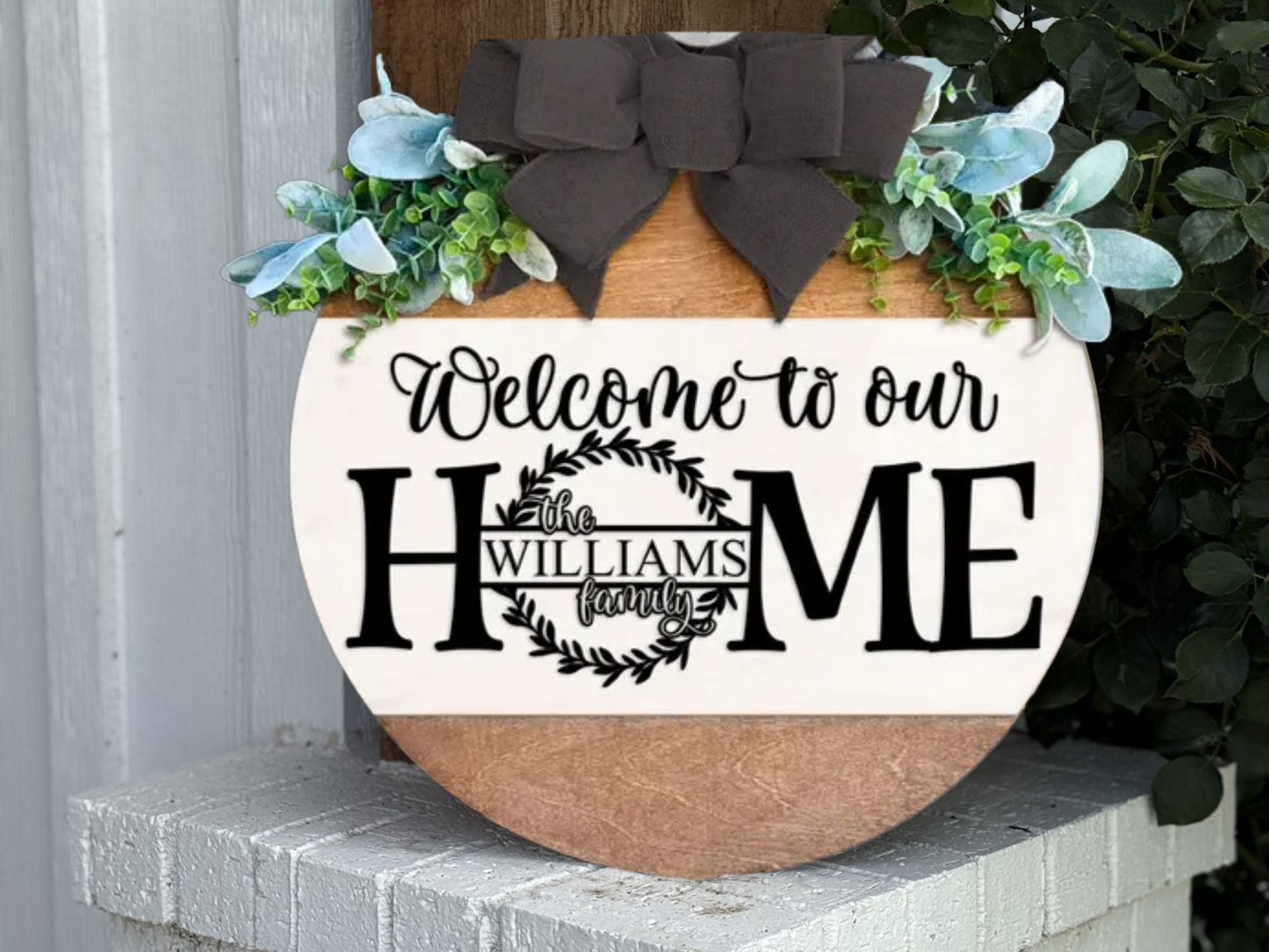 Personalized Welcome to Our Home Sign – Custom Family Name Door Hanger, Farmhouse Layered Wood Home Decor with Bow and Greenery