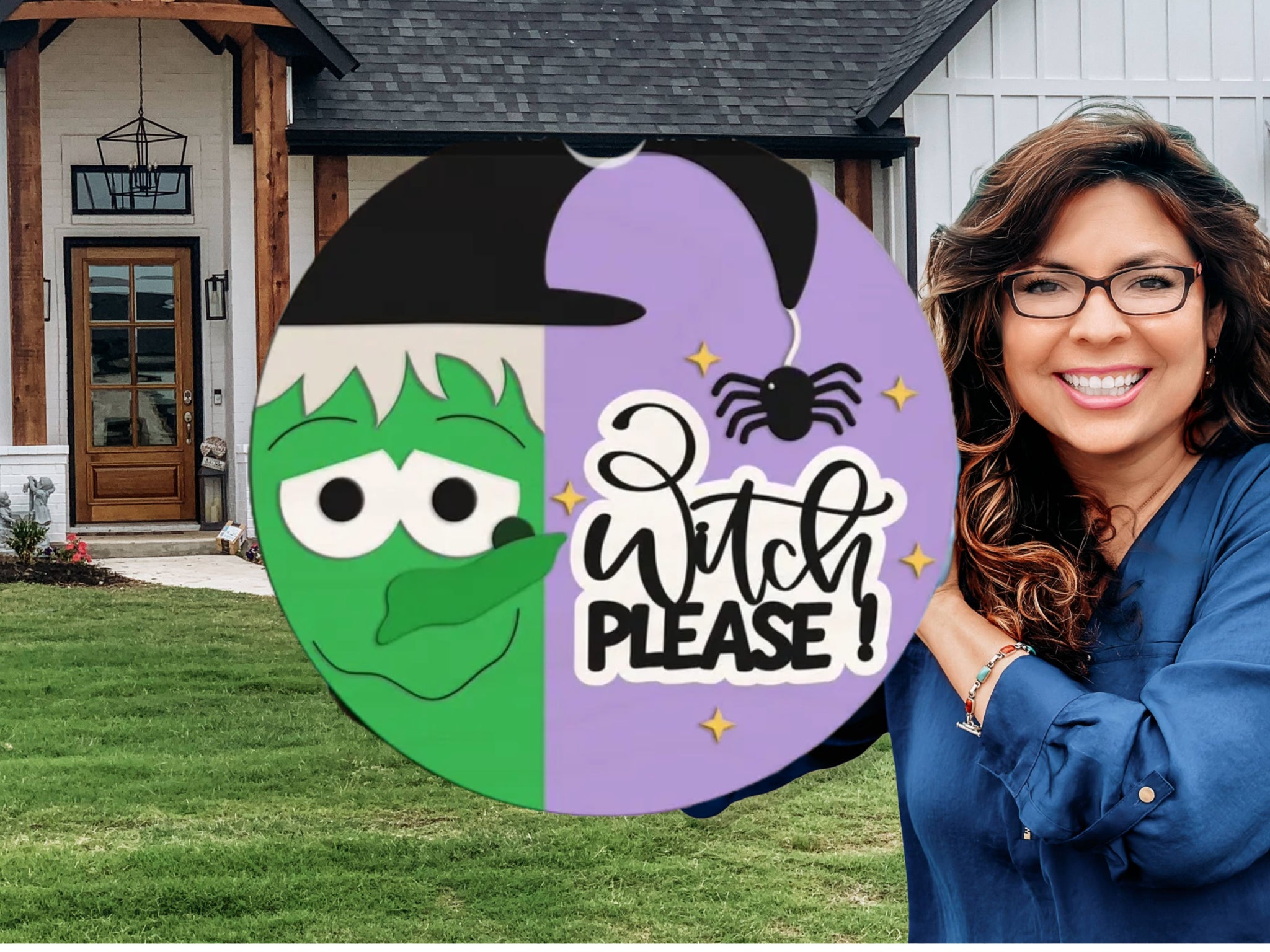A smiling woman with long brown hair and glasses holds a round sign featuring a cartoon witch, a spider, and the words Witch Please! in front of a modern house with wood and white siding.